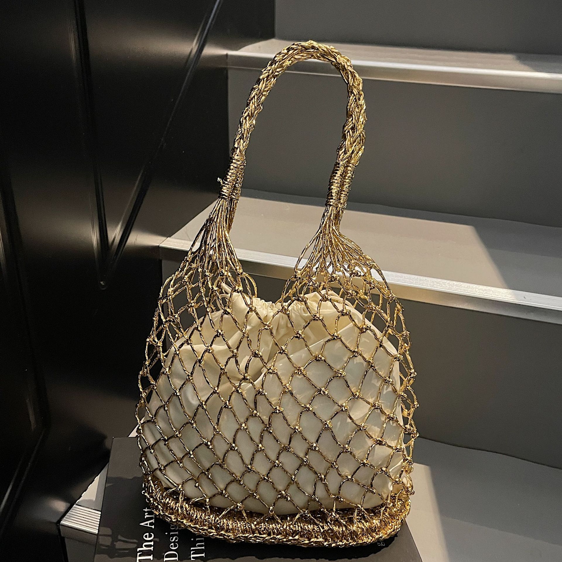 The new solid-color gold and silver thread hand-woven bag from ins is trendy and fashionable. It's a forest-style hand-held beach woven bag details Picture