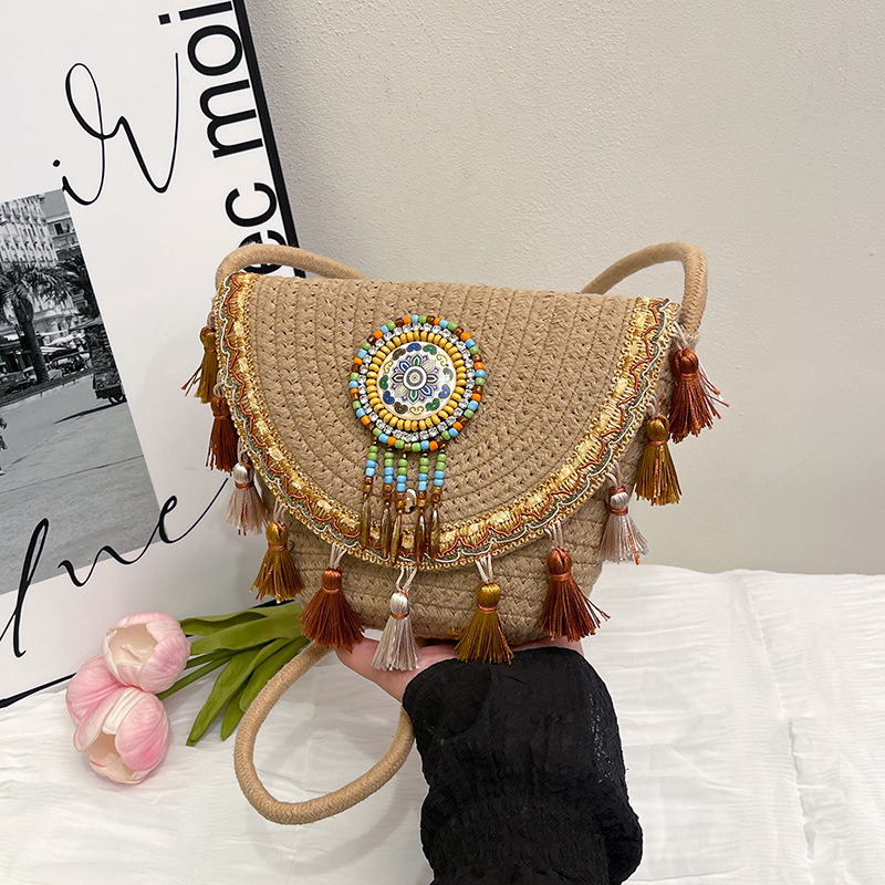 2025 New style simple ethnic style fashionable and trendy straw woven bag with tassel balls, simple crossbody shoulder bag full figure