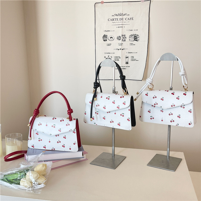 A fresh and elegant cherry fashion handbag for women in summer 2025, a trendy and niche crossbody bag, a sweet and stylish small square bag Application Scenario