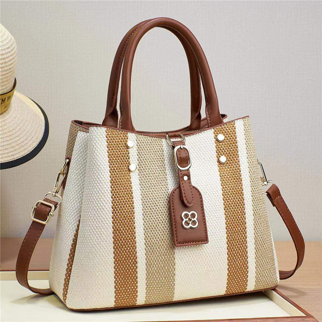 The 2023 new hand-held crossbody single-shoulder bag for foreign trade women is a fashionable cross-border bag with woven and embossed patterns. It has a large capacity and contrasting colors full figure