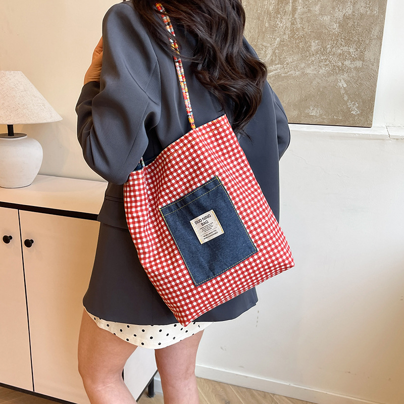 A new summer 2025 casual tote bag for college students, featuring a double-sided checkered backpack and a unique artistic style Application Scenario