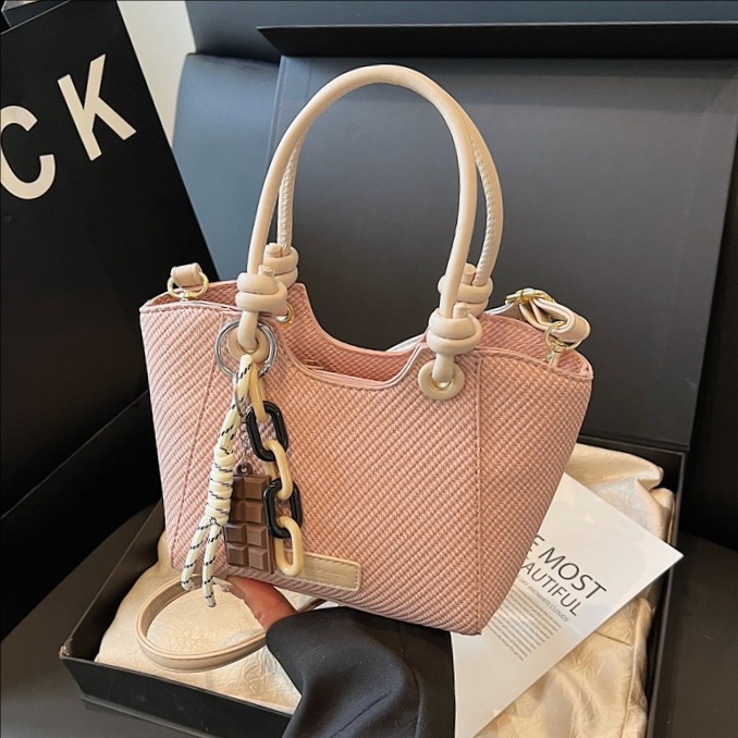 A trendy and fashionable hand-held bucket bag for women in 2025, featuring a high-end commuting look with woven patterns and a single-shoulder crossbody design full figure