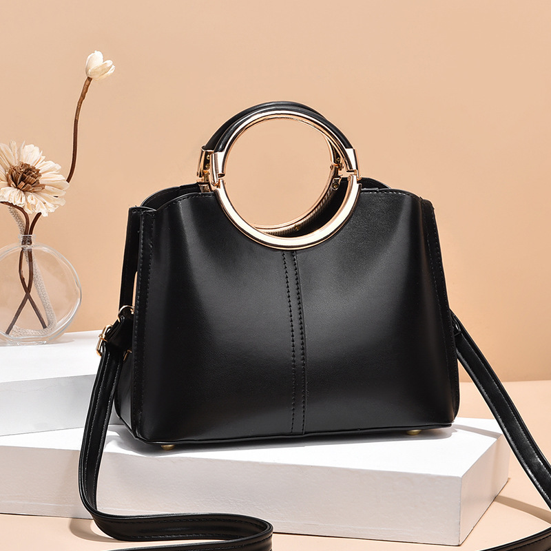 The new round handbag is a Korean version of a fashionable women's single-shoulder crossbody bag. It is simple, large-capacity and multi-layered for women details Picture