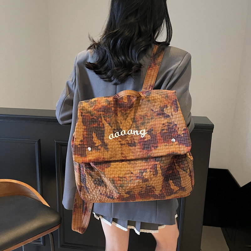 2025 New trendy water-dyed fabric camouflage large-capacity backpack for women, lightweight and portable letter travel backpack details Picture