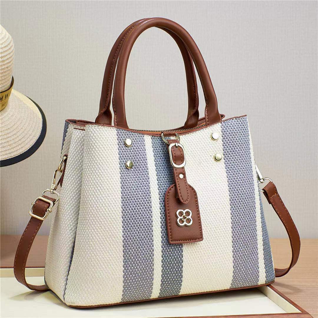 The 2023 new hand-held crossbody single-shoulder bag for foreign trade women is a fashionable cross-border bag with woven and embossed patterns. It has a large capacity and contrasting colors details Picture