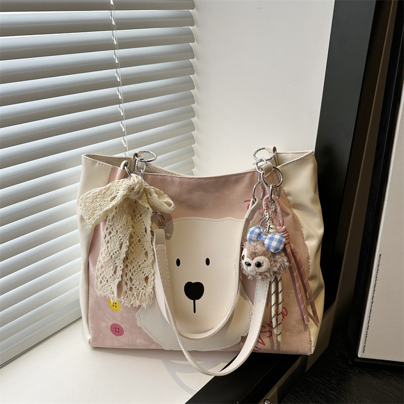 This is a new style of women's bag for 2025, featuring a fashionable and cute dog-patterned design. It's a single-shoulder crossbody bag and a literary bucket bag full figure