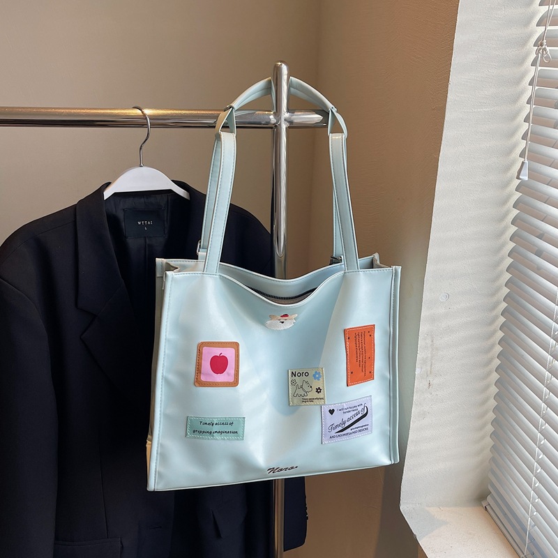 The 2025 new backpack is fashionable and versatile. The large-capacity tote bag is simple and cute for women. The cartoon sticker single-shoulder bag is trendy Application Scenario