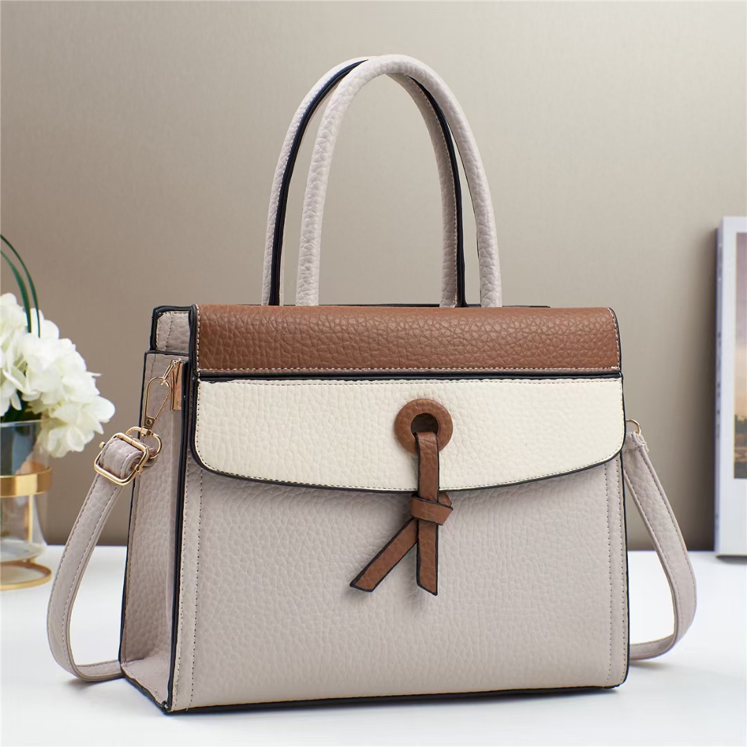 The new color-blocking handbag for foreign trade is a versatile single-shoulder tote bag with a fashionable color contrast and a high-end feel. It is a trendy crossbody bag with a patchwork design full figure