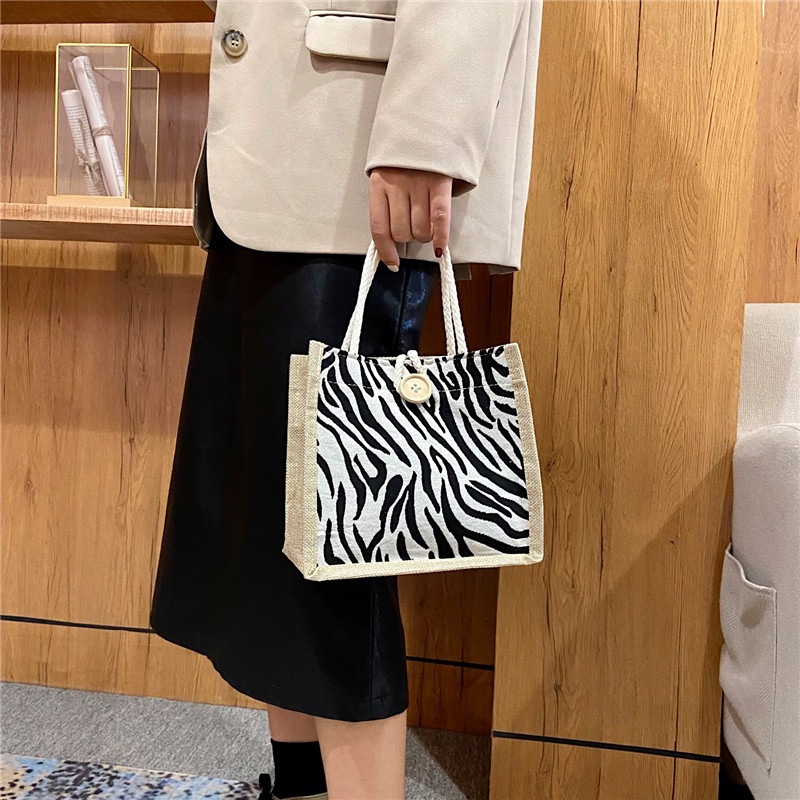 2022 New hand-held canvas women's bag, large capacity, fashionable thousand-bird pattern shopping shoulder bag, student class lunch bag details Picture