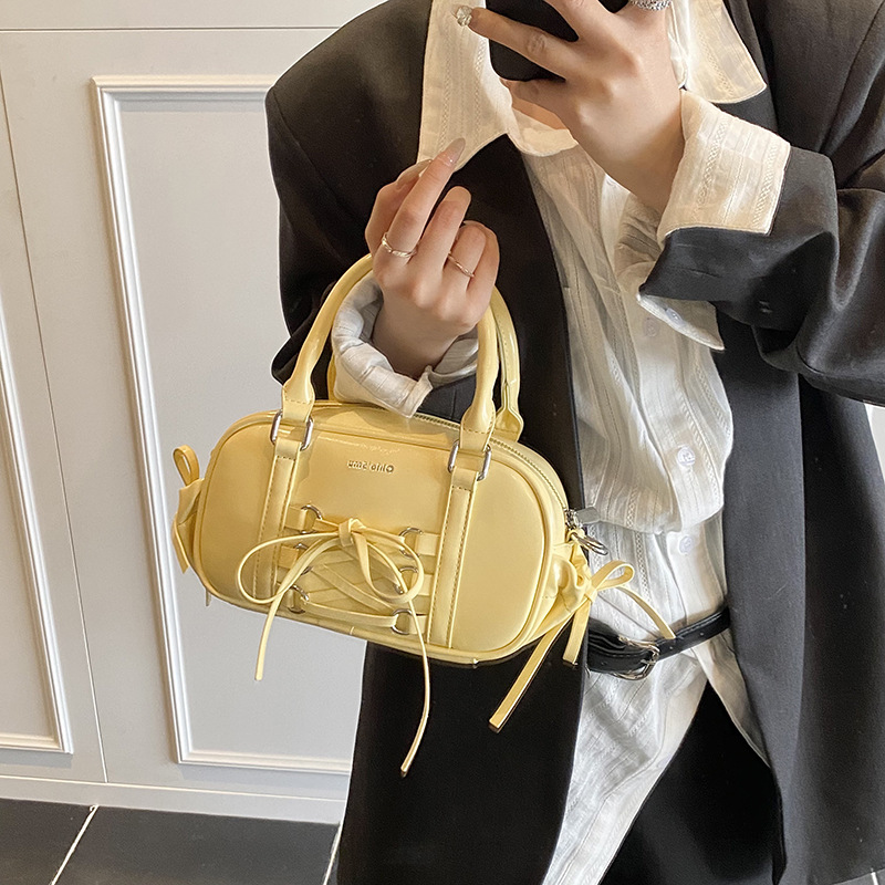 A trendy and simple hand-held pillow bag for women in 2025, with a stylish bow and a single-shoulder, crossbody bowling bag details Picture