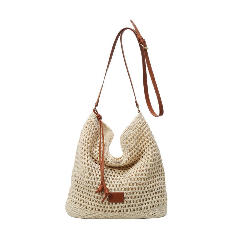 A new 2025 hollowed-out woven large-capacity bucket bag for women's daily commuting during a beach vacation Item Picture