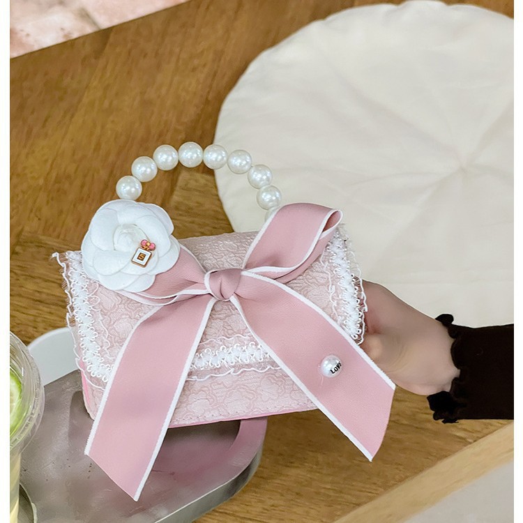 Autumn and winter Korean version bow camellia children's bag Pearl hand-held lace trim kindergarten girl crossbody bag details Picture
