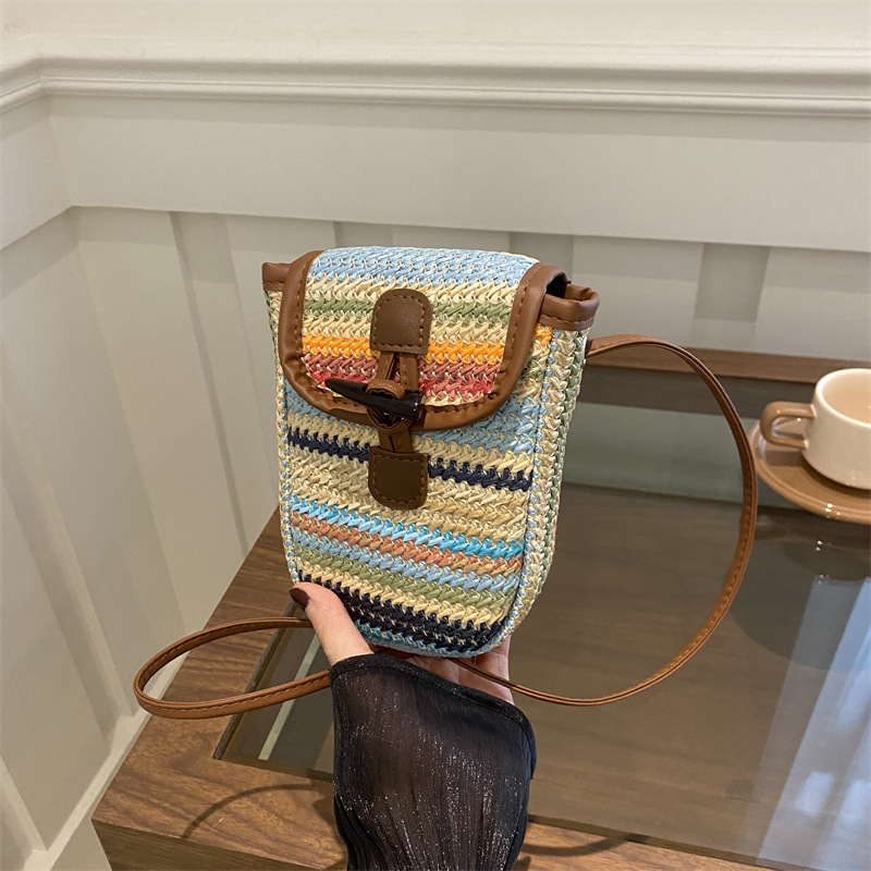 The 2024 new large-capacity, stylish summer rainbow-striped straw weaving bag for women. It is a small square crossbody bag for mobile phones full figure
