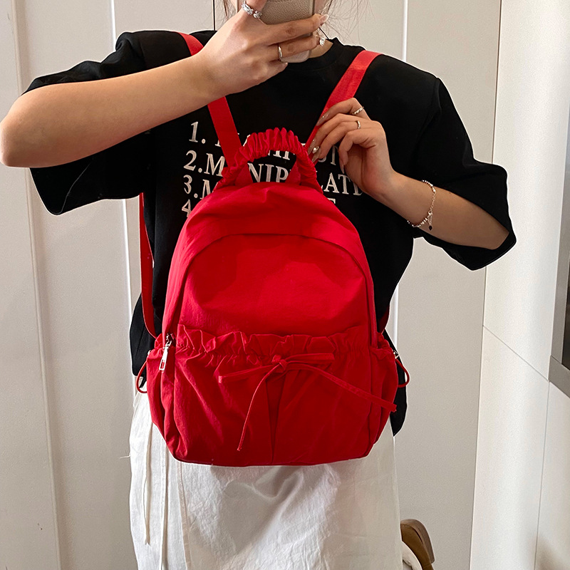 The 2025 new Korean-style niche nylon backpack is a lightweight and versatile travel and outdoor backpack with a large capacity for students full figure
