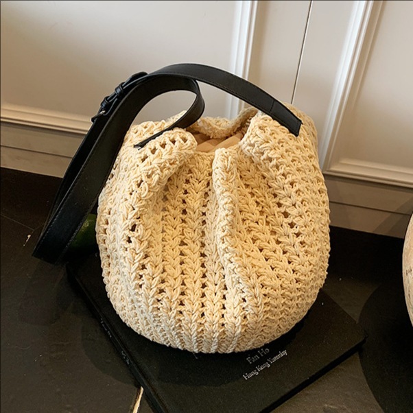 This is a new summer 2025 trendy retro hollowed-out woven single-shoulder bag for women, featuring a seaside vacation style and a large capacity bucket bag full figure