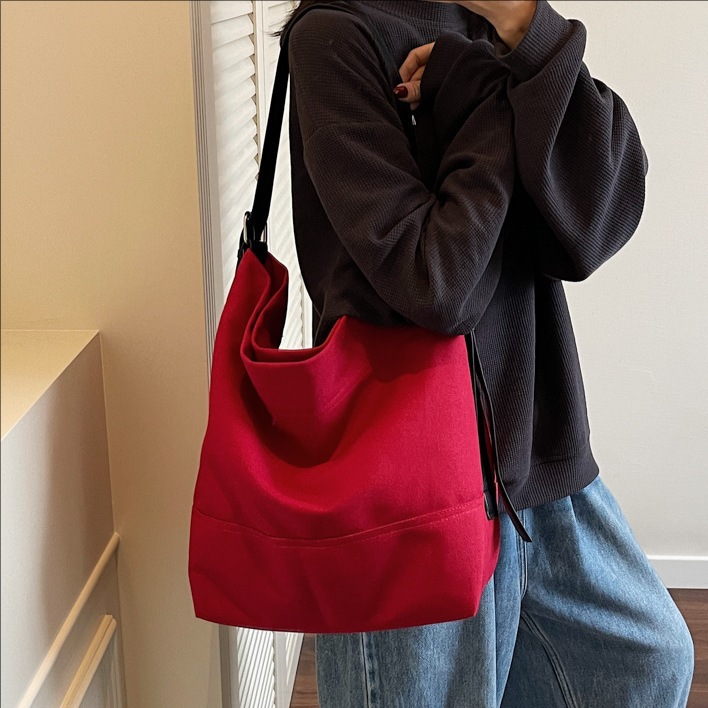 Korean solid color fashionable large-capacity bucket bag for women 2025 new style canvas student commuting single-shoulder crossbody bag full figure