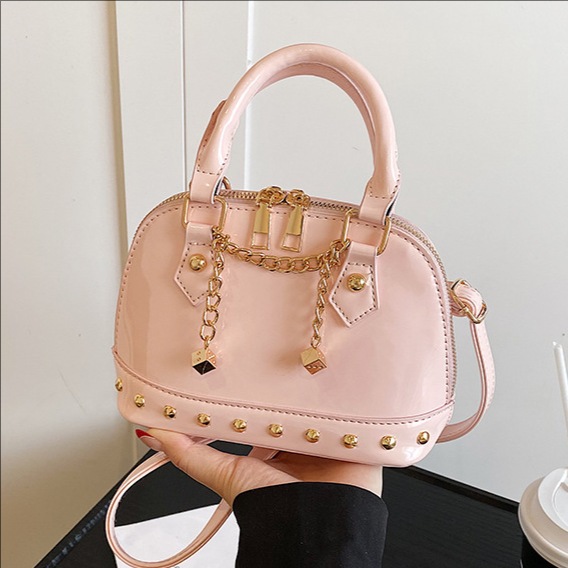 2025 New niche design, high-end rivet hand-held shell bag, fashionable for women, shiny surface, versatile, single-shoulder crossbody bag full figure