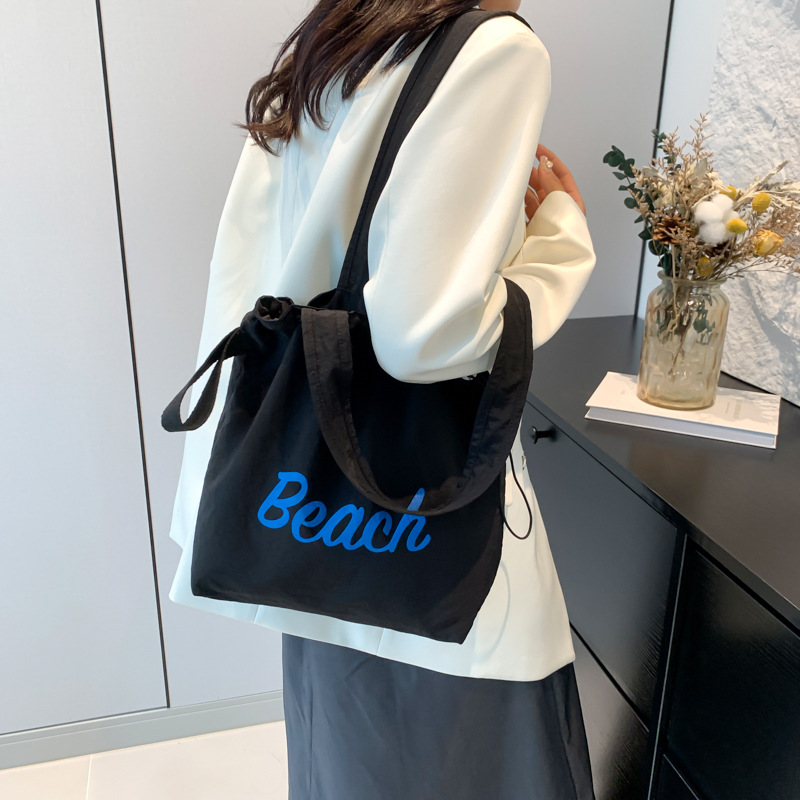 Korean summer new canvas bag, large-capacity shopping bag, commuter single-shoulder bag, simple letter drawstring handbag details Picture