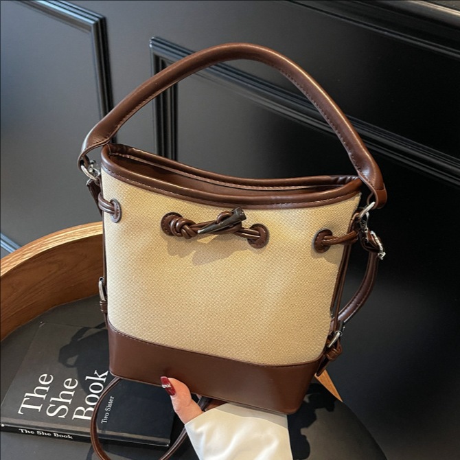 The 2025 new stylish color-blocking drawstring hand-held bucket bag is a versatile, simple and casual single-shoulder crossbody bag for women full figure
