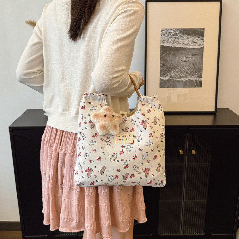The new ins canvas single-shoulder bag for spring and summer is a fresh and large-capacity student class backpack with a cute hand-held canvas bag details Picture