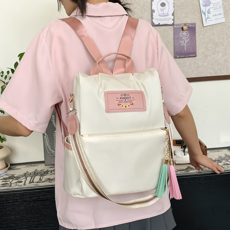 A new summer 2025 student commuting handbag for girls with a niche lightweight backpack from South Korea, featuring color-blocking and spliced crossbody bags details Picture