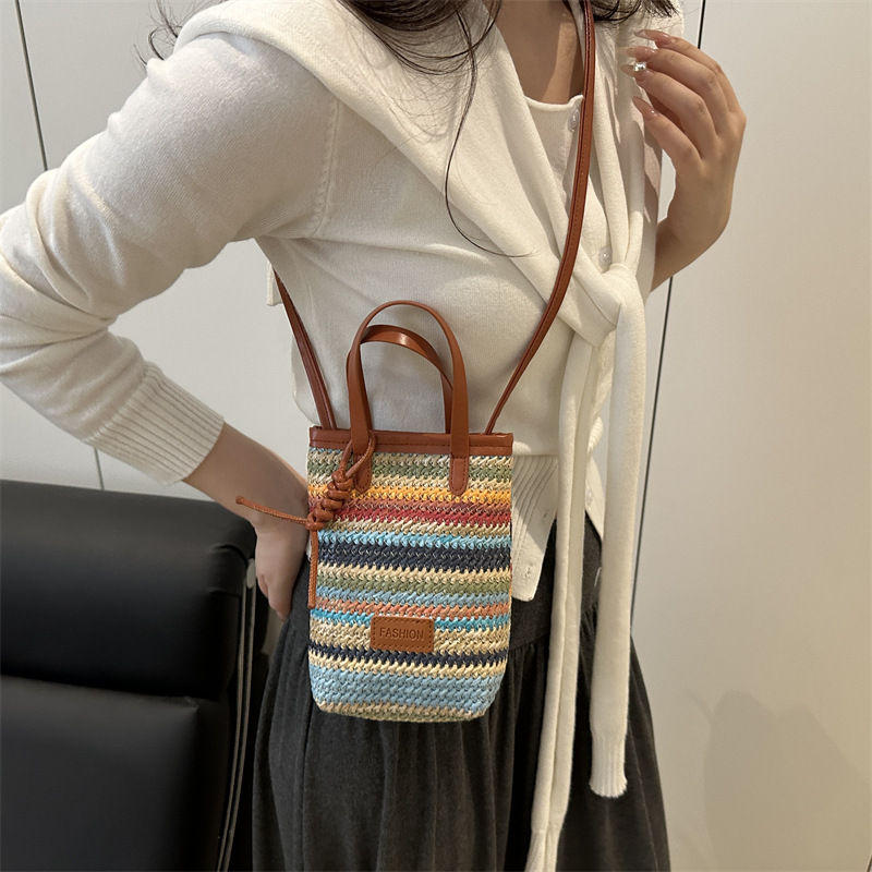 A new and niche design of a women's crossbody bag made of straw weaving in 2025, featuring color-blocking and patchwork ins woven hand-held small bag details Picture