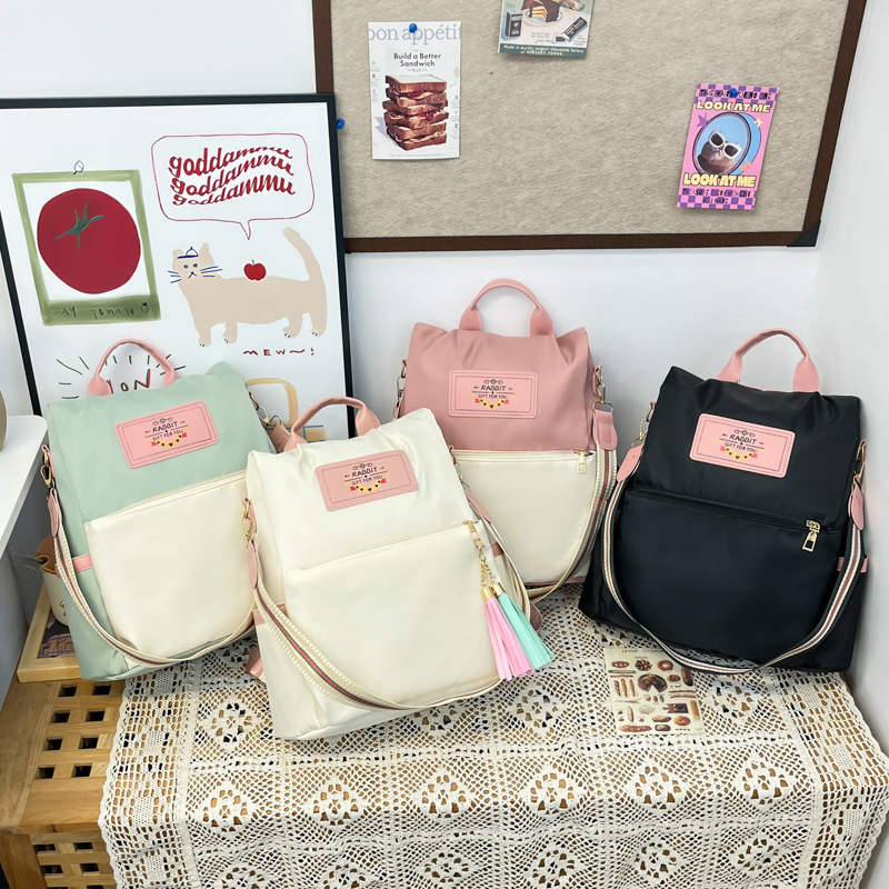 A new summer 2025 student commuting handbag for girls with a niche lightweight backpack from South Korea, featuring color-blocking and spliced crossbody bags Application Scenario