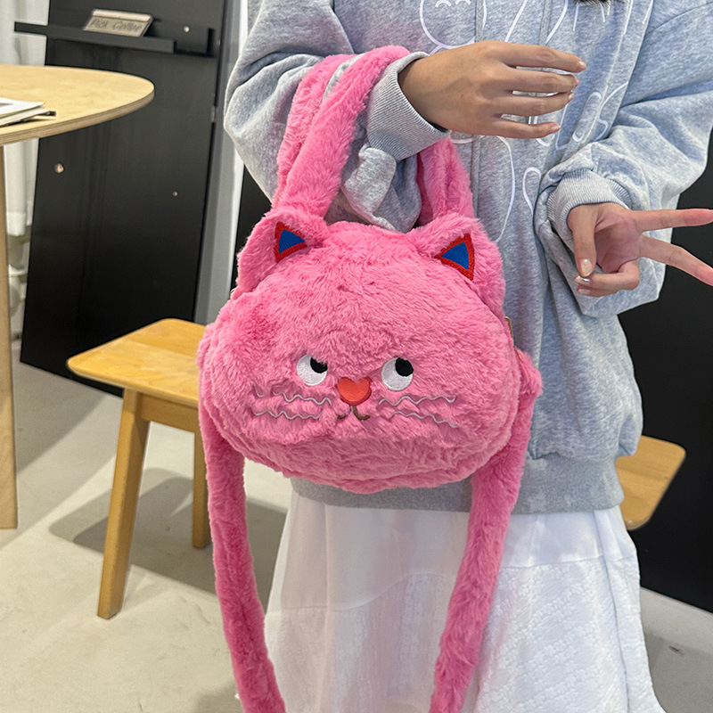 A new style of girl's hand-held crossbody bag with a cute big head doll. Carry the bag when going out to store the crossbody travel bag details Picture