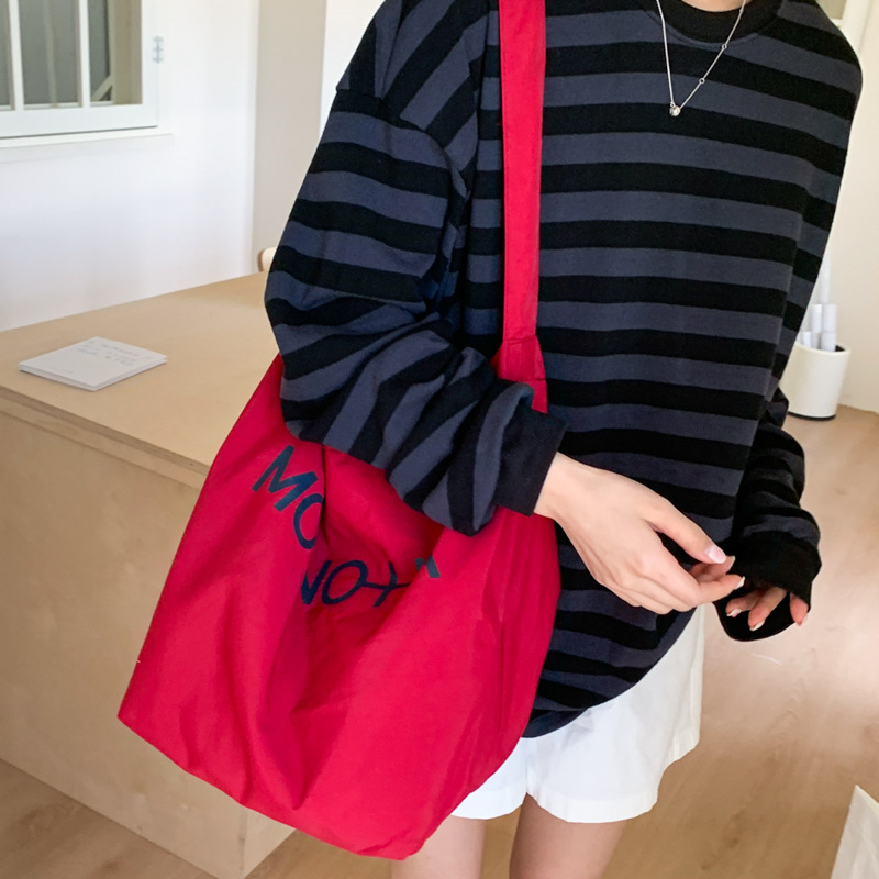2025 New large-capacity student commuting canvas bucket bag, women's fashion letter solid color simple single-shoulder bag full figure