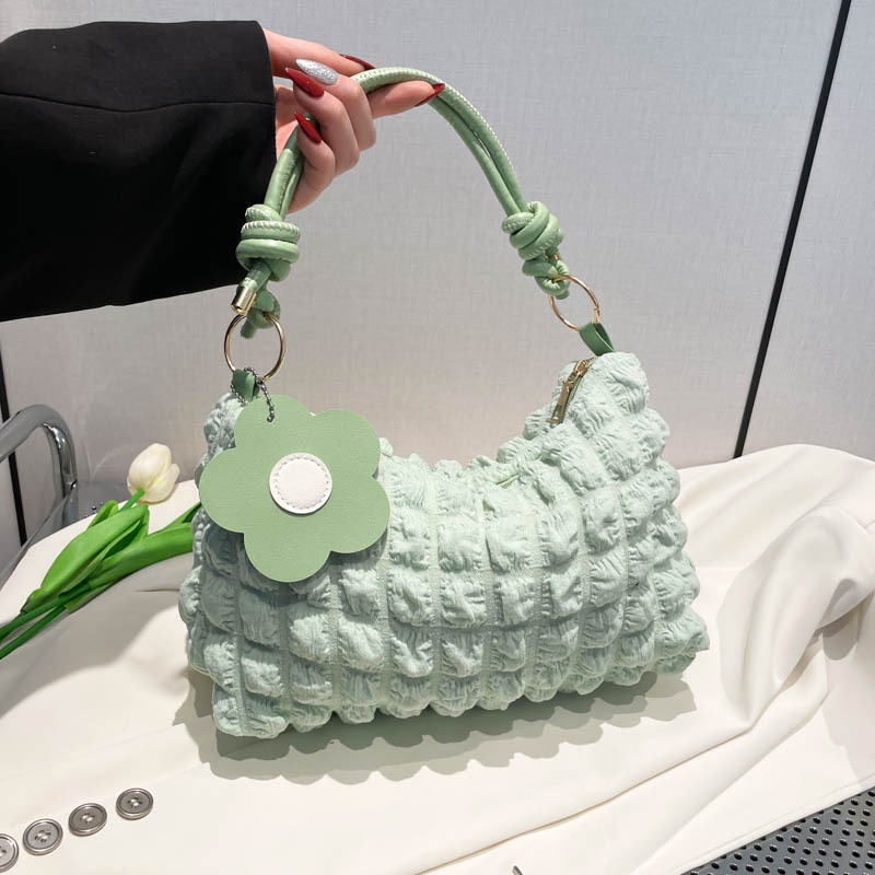 A 2025 new style crossbody bag for women, featuring a large pleated capacity, fashionable Korean style, and a fresh and simple knot shoulder strap full figure