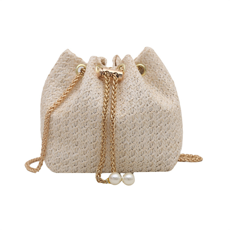 A new summer commuting Korean-style simple solid color single-shoulder crossbody bag for women in 2025, featuring a straw-woven drawstring chain bucket Item Picture