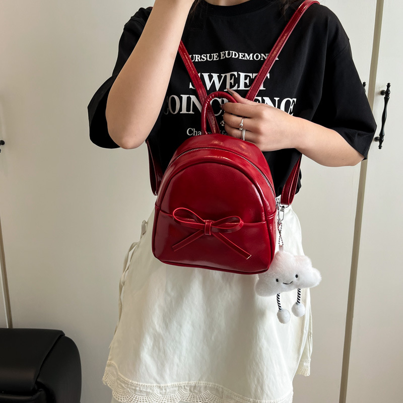 The 2025 spring new Korean-style bow mini backpack, a retro oil-leather women's pu crossbody bag, is a cross-border trend details Picture