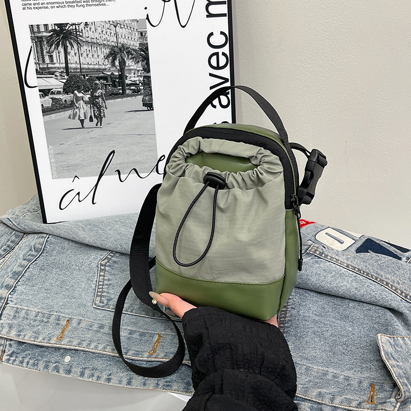 Color-blocking, lightweight, waterproof, spliced, casual and personalized small bag for Spring/Summer 2025, with a drawstring vertical crossbody phone bag full figure