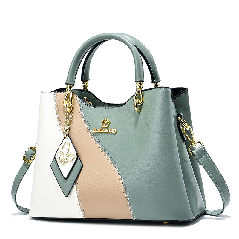 This is a new high-end Korean-style trendy handbag for women in spring 2024. It features a sweet and elegant style with a color-blocking design and a crossbody bag details Picture