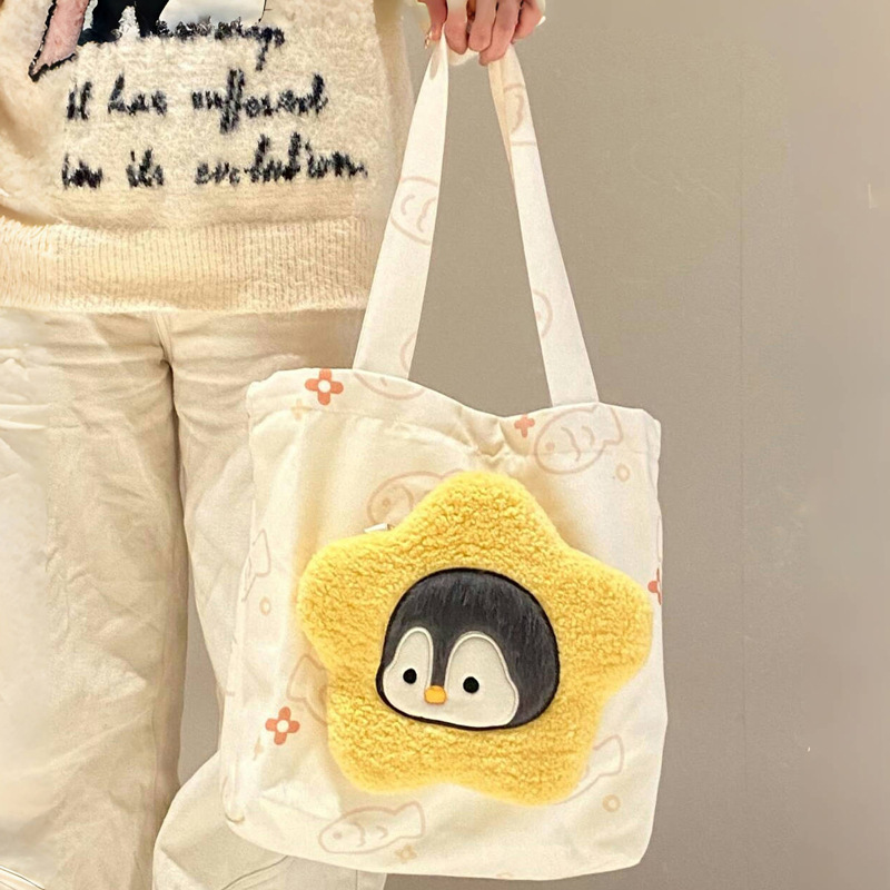 The new printed canvas bag combination is cute and versatile. It features a small penguin plush crossbody bag and a large-capacity tote bag for classes details Picture