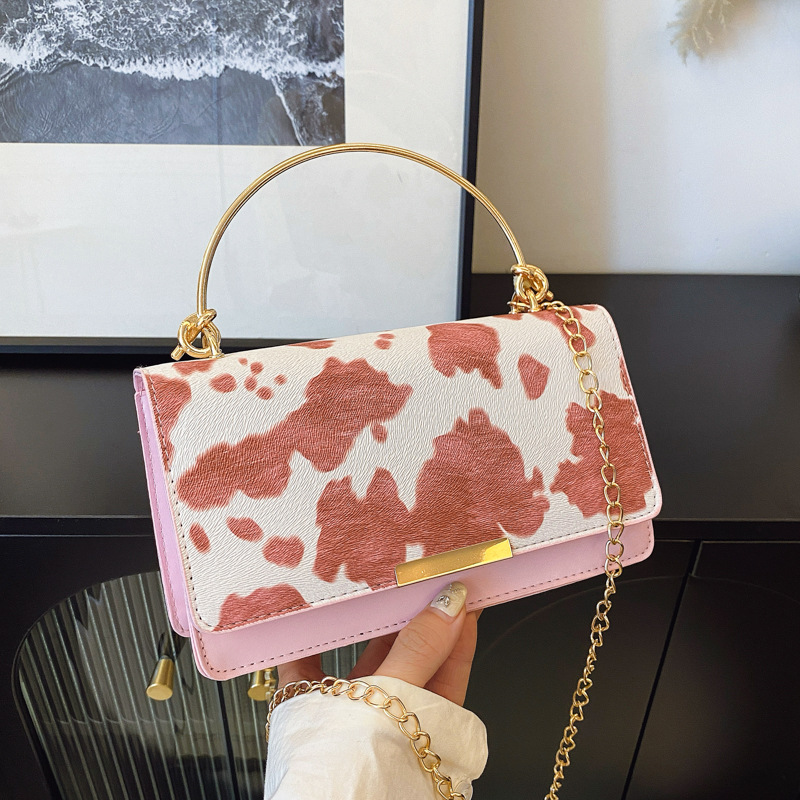 This is a retro and fashionable cow print handbag from Europe and America. It is a new style for women's summer 2025, featuring a high-quality commuting single-shoulder crossbody bag full figure