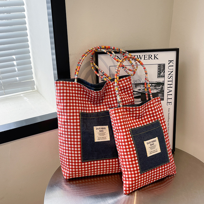 A new summer 2025 casual tote bag for college students, featuring a double-sided checkered backpack and a unique artistic style full figure