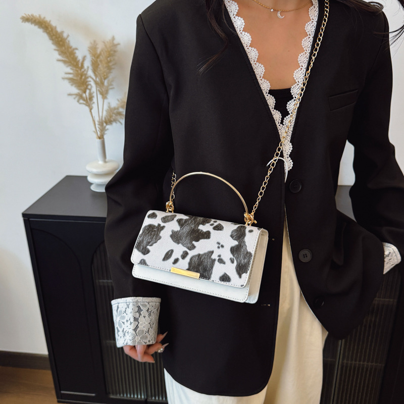 This is a retro and fashionable cow print handbag from Europe and America. It is a new style for women's summer 2025, featuring a high-quality commuting single-shoulder crossbody bag details Picture