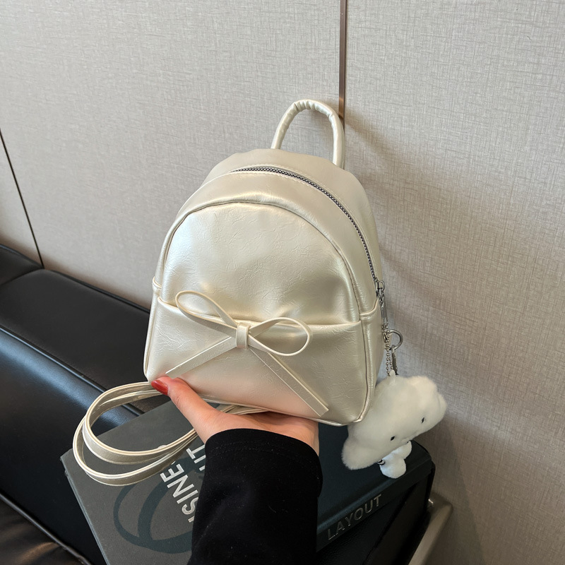 The 2025 spring new Korean-style bow mini backpack, a retro oil-leather women's pu crossbody bag, is a cross-border trend full figure