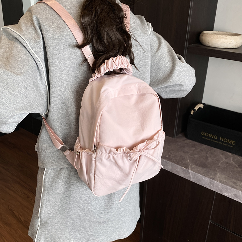 Japanese-style artistic, fresh and elegant lady with a bow, fashionable single-shoulder bag, pleated nylon fabric, casual and versatile backpack Application Scenario