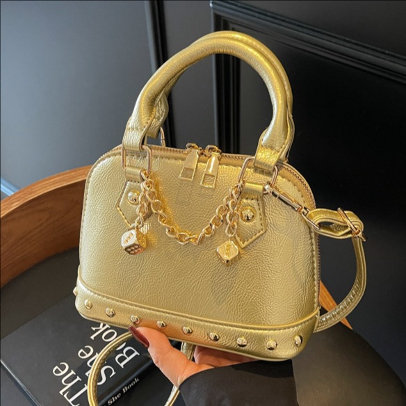 2025 New niche design, high-end champagne rivet hand-held shell bag, fashionable and stylish for women, single-shoulder crossbody bag full figure
