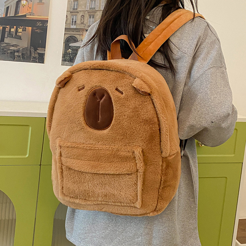 A new cartoon plush backpack for girls in 2024, featuring a cute strawberry bear, beaver and capybara, with a large capacity for class Application Scenario