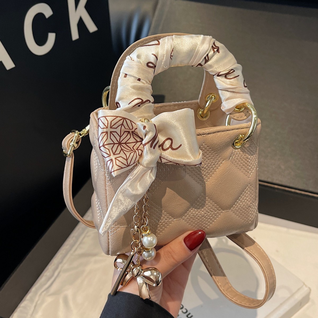 A trendy and fashionable mini handbag designed for women in 2025, a versatile crossbody bag with a red envelope opening full figure