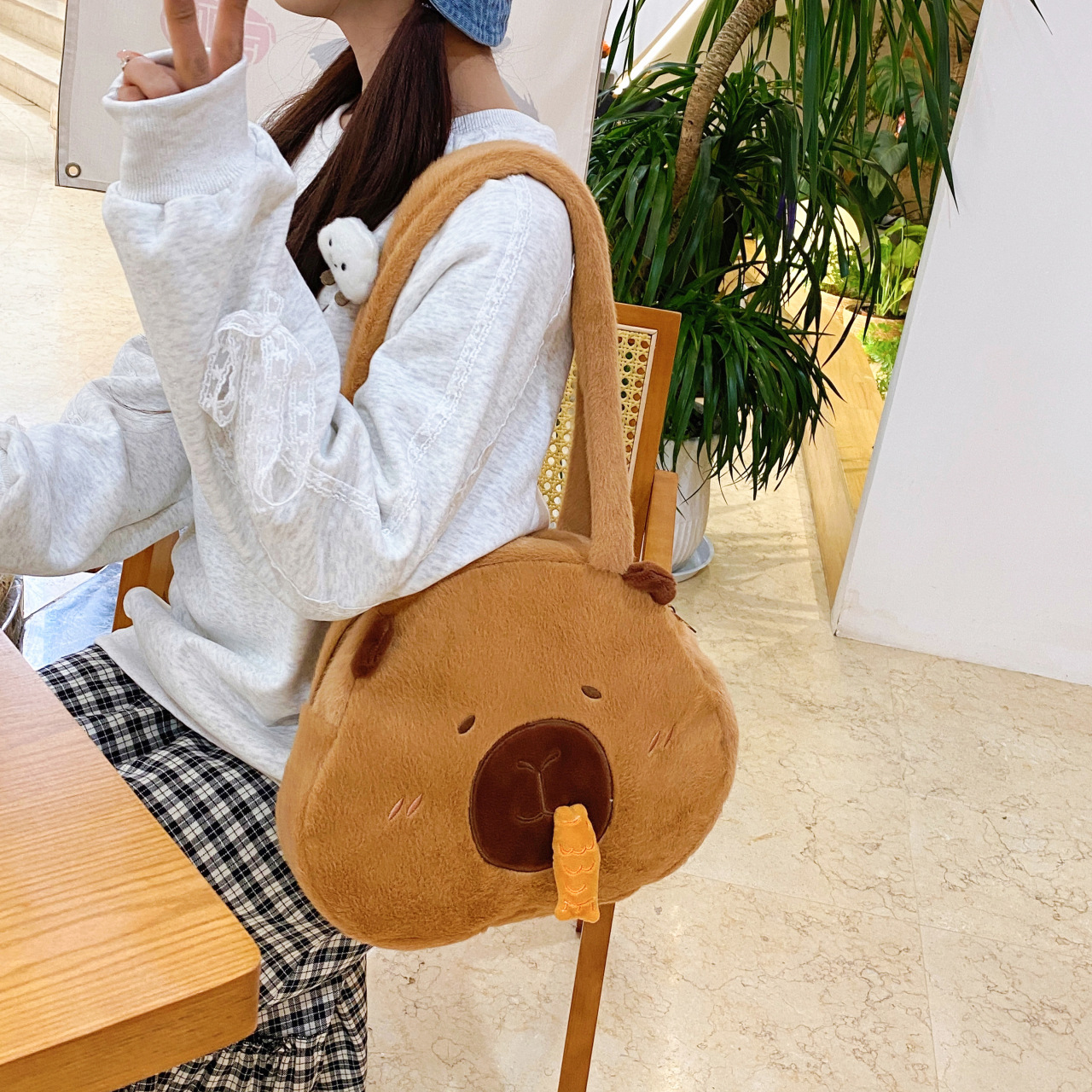 A new cartoon underarm single-shoulder handbag with a large capacity, a capibara stretchable snot pufferfish student storage bag Application Scenario