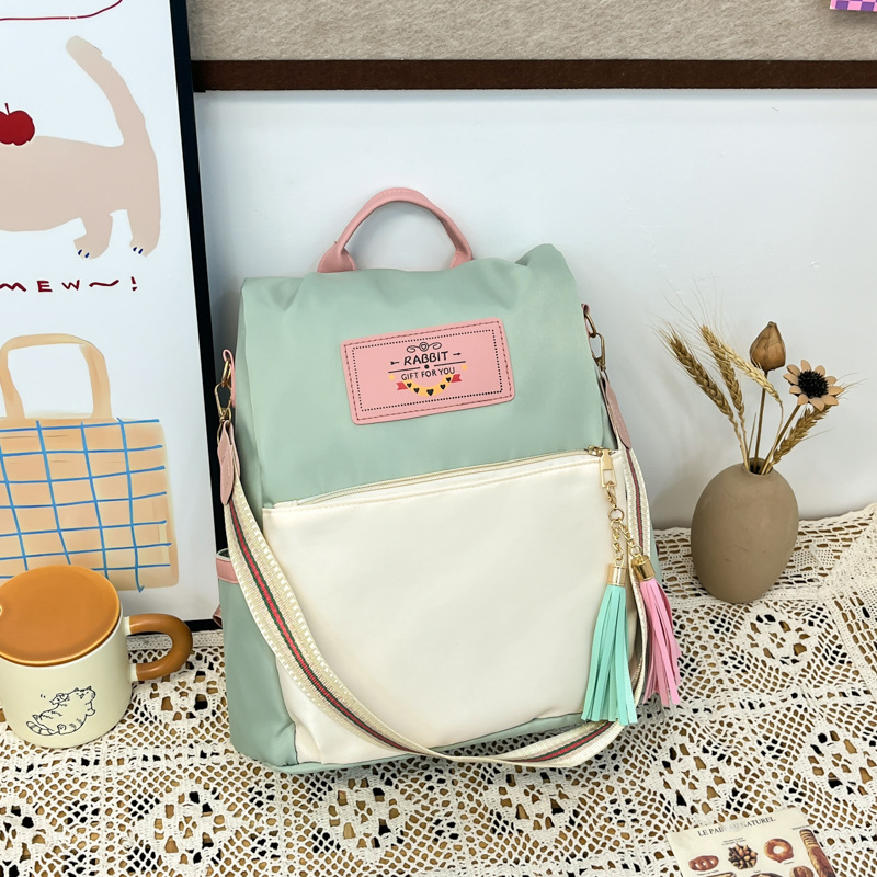 A new 2025 Korean student commuting backpack with a unique color-blocking and patchwork design full figure