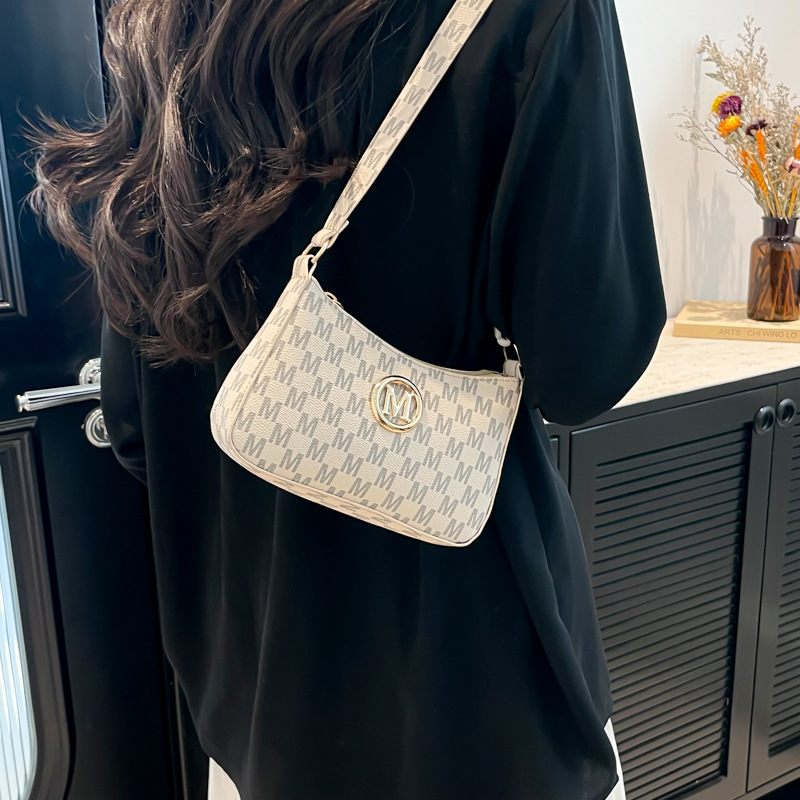 This is a trendy underarm bag with a unique and individualistic style. It's a fashionable small bag for women in 2025, featuring a slanted cross and a small square bag for women details Picture