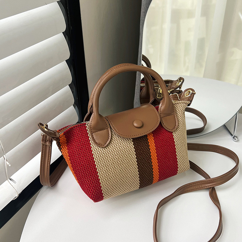 The new Spring/Summer 2024 Korean-style hand-held dumpling bag is a trendy and high-quality fabric striped single-shoulder crossbody bag full figure
