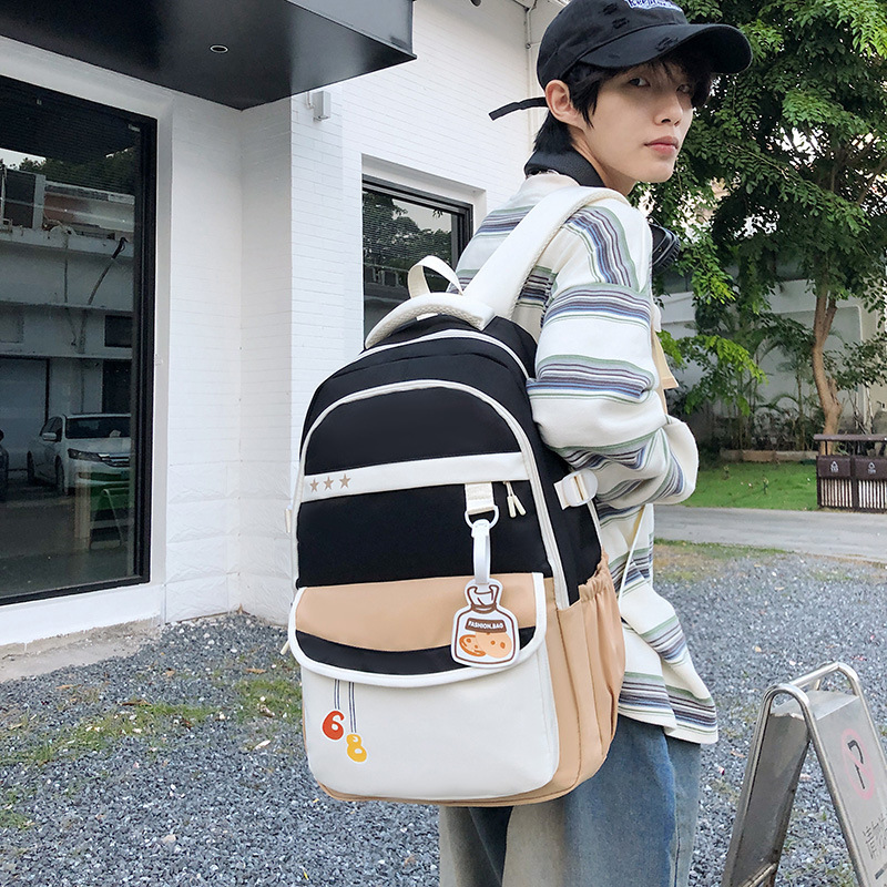 The new college student backpack features a contrasting color, is lightweight and has a large capacity. It is a retro workwear backpack Application Scenario