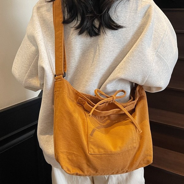 Solid-color canvas crossbody bag for women, bow-designed postman bag, large-capacity single-shoulder bag for women, and schoolbag for students full figure