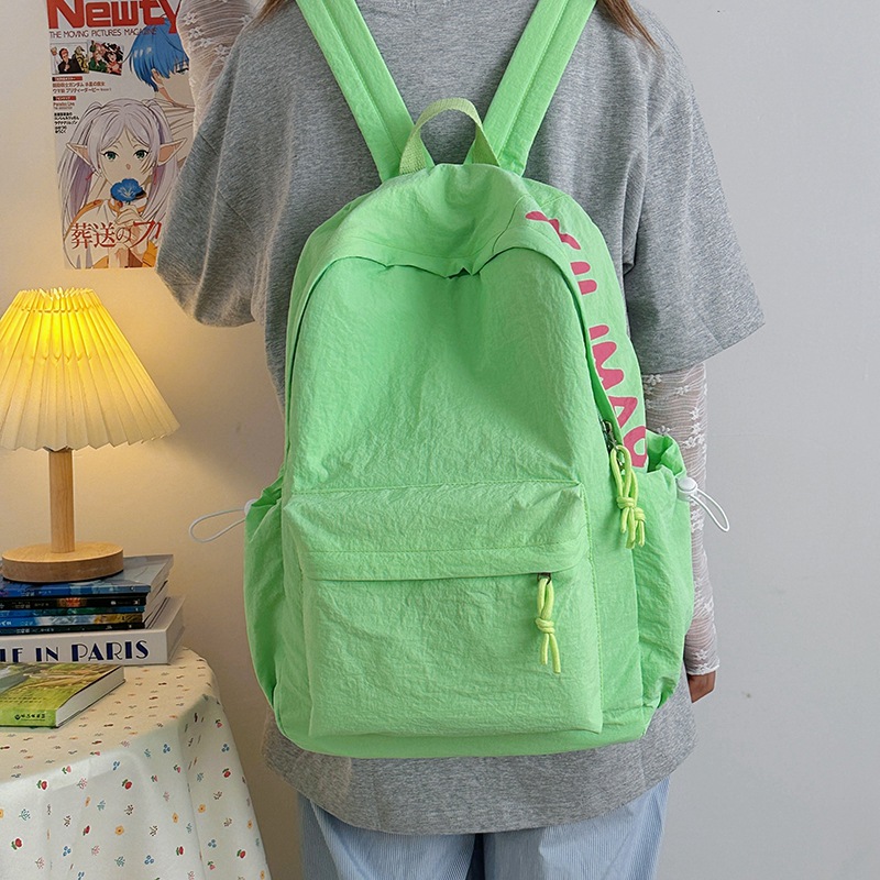 Solid-color campus backpack, simple forest style, versatile color-blocking letter backpack, ins style, large-capacity commuting schoolbag for girls Application Scenario